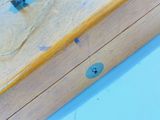 a close up of a piece of wood with a screw on it