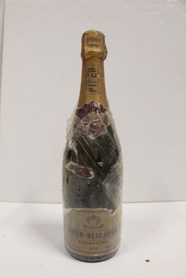 a bottle of wine wrapped in plastic and sitting on a table