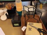 a table with a bunch of papers and a pair of scissors on it