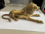 a gold statue of a lion sitting on a piece of paper