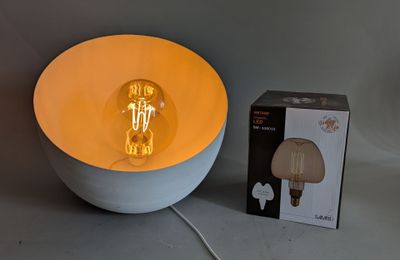 a light that is on in a bowl next to a box