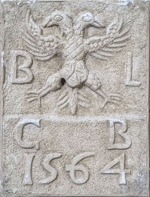 a close up of a stone plaque with a bird on it