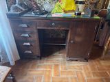 a wooden desk with a glass top in a room