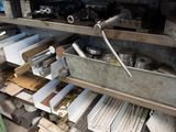 a metal shelf with many different types of tools on it
