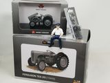 a toy man sitting on top of a tractor in a box