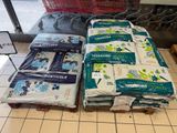 many bags of diapers sitting on the floor in a store