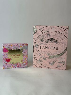 a pink box with a clock on it next to a pink box with a clock on it