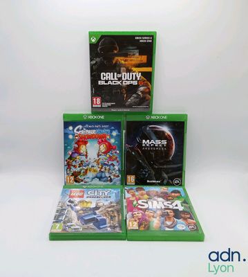 the xbox game collection is on display on a white surface