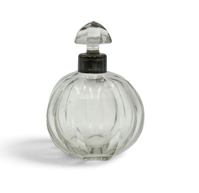 a clear glass bottle with a black top on a white surface