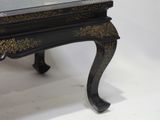 a black and gold table with a glass top on a white background