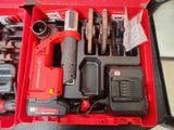 a red tool box with tools in it on a table