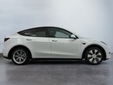 the tesla model x is parked in a white room