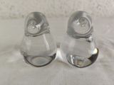 two salt and pepper shakers sitting on a table