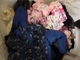a pile of clothes that is on a bed