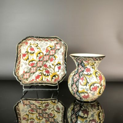 two vases that are sitting on a table