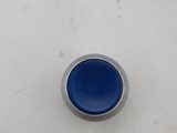a close up of a blue button on a white surface