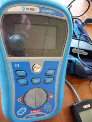 a blue cell phone sitting on top of a wooden table