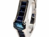 an image of a silver ring with a blue stone in the middle