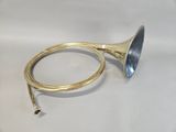 an antique brass trumpet with a blue bell on a white background