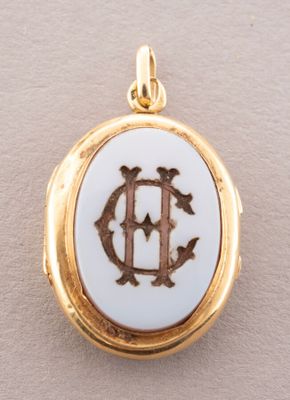 a close up of a gold and white locke with the letter d on it
