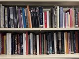 a book shelf with many books on it in a library