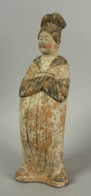an old figurine of a woman with a hat on her head