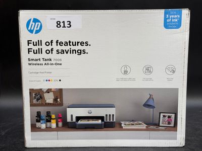 the box is open on the desk with a printer and other items