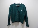 the sweater is green and has a white logo on it
