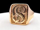 a close up of a gold signet ring with the letter s on it