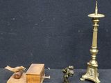 a small statue of a man standing next to a candle and a box