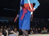 a woman that is walking down the runway in a blue dress