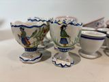 many cups and saucers sitting on a table