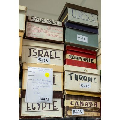 many boxes stacked on top of each other in a room