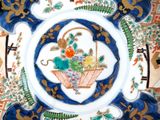 a decorative plate with a basket of flowers on it