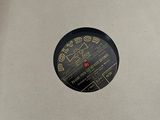 an old record sitting on top of a wooden table next to a wall