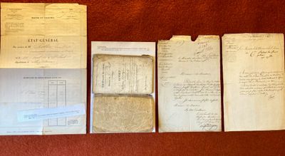 several old papers are lined up on a table