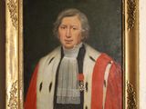 portrait of a man in a red robe and white mantler