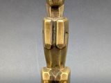 a gold statue of an egyptian cat on a pedestal