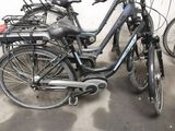 many bikes that are parked in a row in a garage