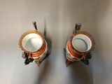 two vases that are sitting on a table