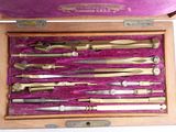 many different types of surgical instruments in a wooden box