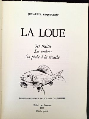 an open book with a drawing of a fish on it ' s cover
