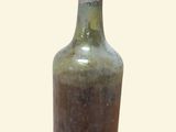 a green glass bottle with a brown top