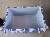 a blue and white planter sitting on the floor