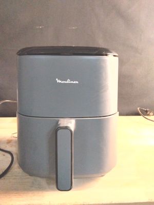 a small air fryer sitting on a wooden table