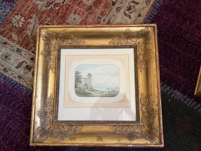 a picture of a picture in a gold frame on the floor