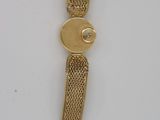 an image of a close up of a gold watch on a white surface