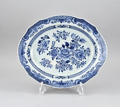 a blue and white plate with a floral design on it