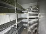 a metal rack in the middle of a room with shelves