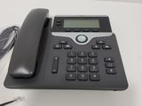 an image of a telephone on a desk with a cord